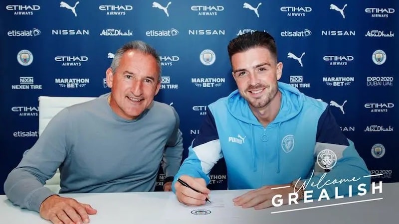 jack grealish signing his new £100 million contract at Manchester City Football Club