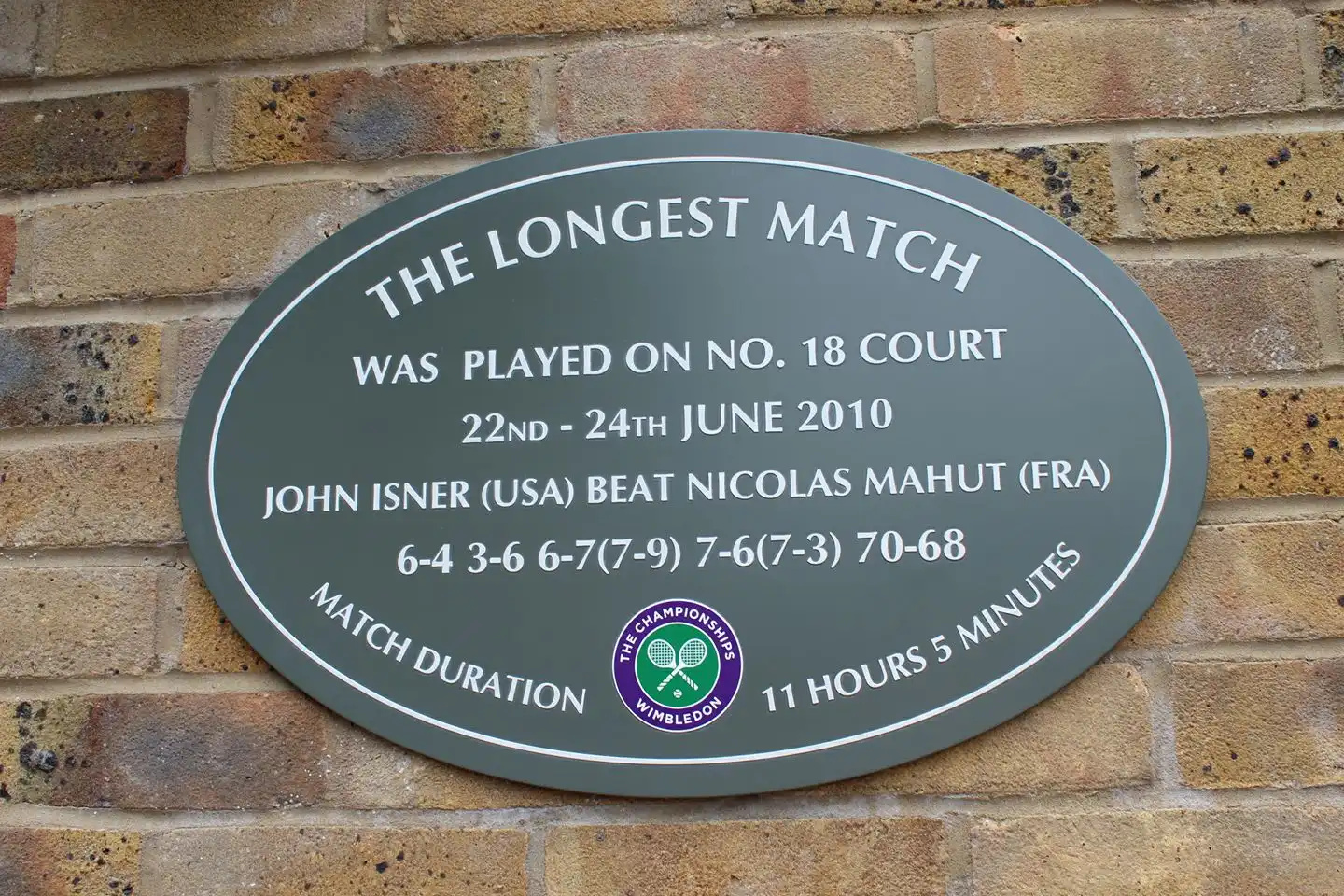 Photo of a plaque with an inscription about the longest tennis match